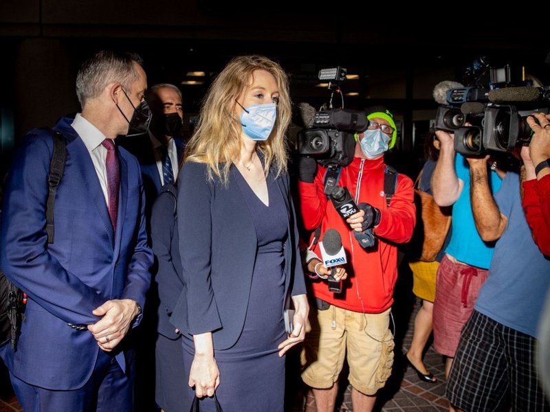 Theranos founder Elizabeth Holmes enters the Robert F. Peckham Federal Building with her defense team on August 31, 2021 in San Jose, California. Holmes is on trial after being indicted on multiple counts of fraud for misrepresenting her company's blood-t