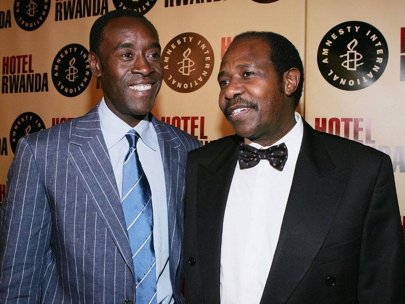 LOS ANGELES - DECEMBER 2: Actor Don Cheadle (L) and real life inspiration for the film Paul Rusesabagina (R) attend the premiere of the United Artists film "Rwanda" December 2, 2004 in Los Angeles, California. (Photo by Carlo Allegri/Getty Images) *** Loc