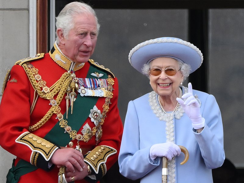 In this file photo taken on June 02, 2022 Britain's Queen Elizabeth II (R) stands with Britain's Prince Charles, Prince of Wales to watch a special flypast from Buckingham Palace balcony following the Queen's Birthday Parade, the Trooping the Colour, as p