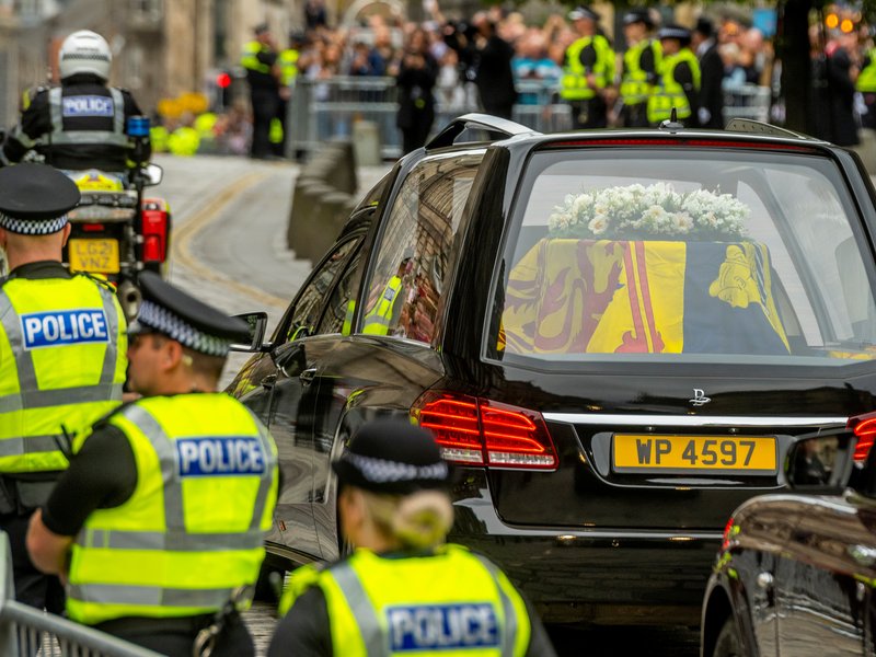 The hearse carrying the coffin of Queen Elizabeth II, draped in the Royal Standard of Scotland, is driven in Edinburgh, en-route towards the Palace of Holyroodhouse, on September 11, 2022. The coffin carrying the body of Queen Elizabeth II left her belove