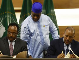 Redwan Hussein (L), Representative of the Ethiopian government, and Getachew Reda (R), Representative of the Tigray People's Liberation Front (TPLF), sign a peace agreement between the two parties during a press conference regarding the African Union-led