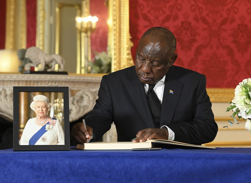 President Cyril Ramaphosa signs a book of condolence at Lancaster House in London