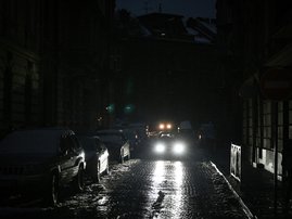 Cars drive along a dark road in Lviv as the city lives through a scheduled power outages on November 24, 2022, after the latest Russian massive airstrikes on the Ukrainian energy infrastructure, amid the Russian invasion in Ukraine.