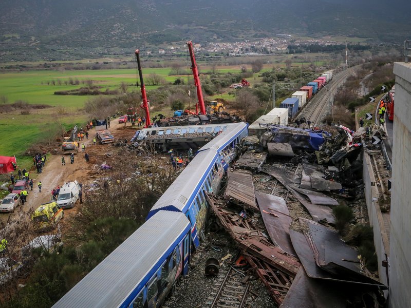 Police and emergency crews search the debris of a crushed wagon after a train accident in the Tempi Valley near Larissa, Greece, March 1, 2023.