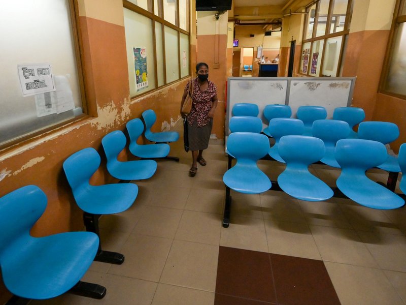 A patient waits for the treatment in a deserted government hospital in Colombo on March 15, 2023. Bankrupt Sri Lanka's hospitals were crippled and transport disrupted on March 15 as trade unions protested against the doubling of taxes to qualify for a cru