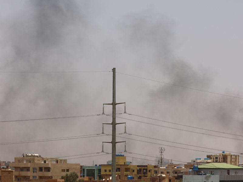 Smoke billows behind residential buildings in eastern Khartoum on April 17, 2023, as fighting in Sudan