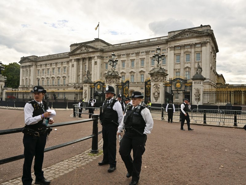 Metropolitan Police officers on duty outside of Buckingham Palace.