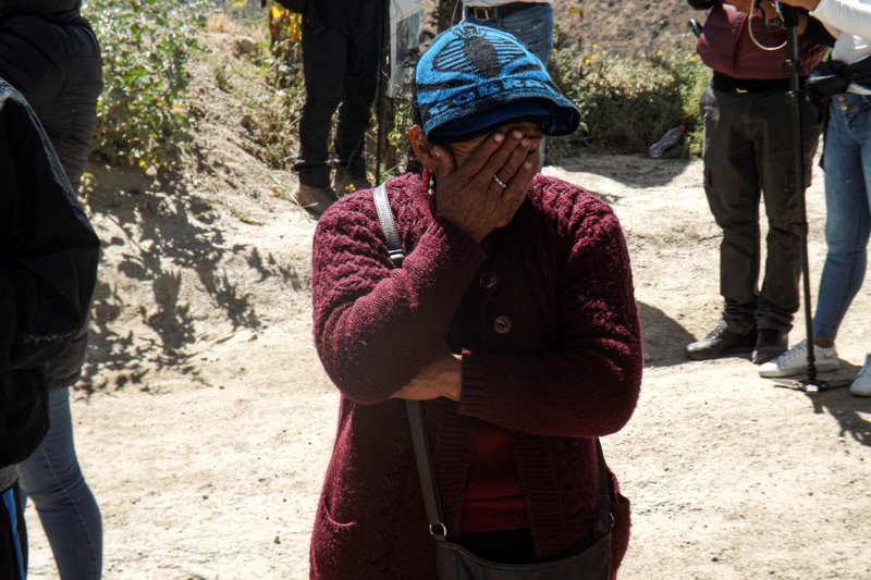 A relative of a miner cries as she waits at the entrance of the La Esperanza mine, where at least 27 people died in the Yanaquihua district of Arequipa, southern Peru, on May 7, 2023.
