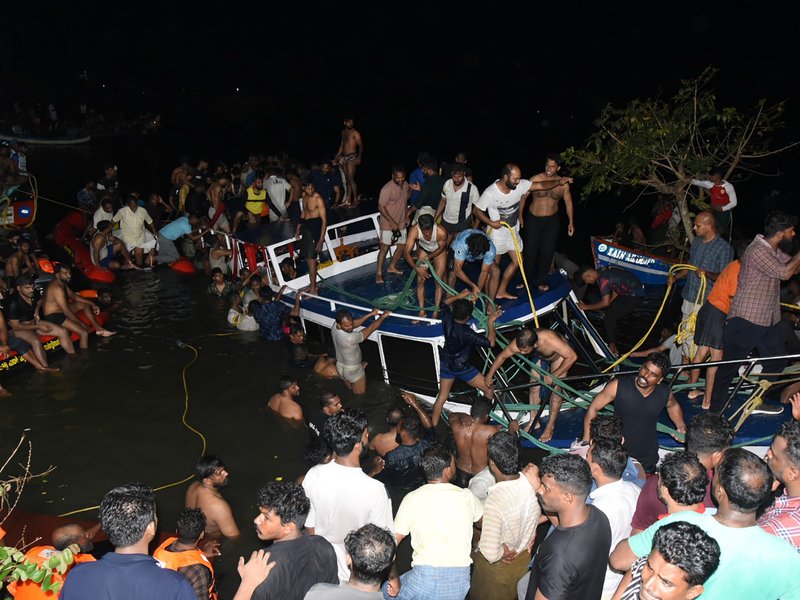 In this photograph taken on May 7, 2023, people carry out rescue operation at the site of a boat accident in Tanur, in Malappuram district of India's Kerala state.