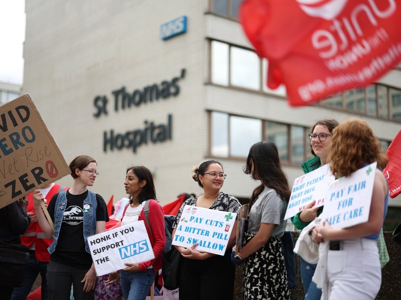 Junior doctors hold placards at a picket line outside St Thomas' Hospital in London on July 13, 2023 in the biggest walkout in the history of the UK's state-funded National Health Service.