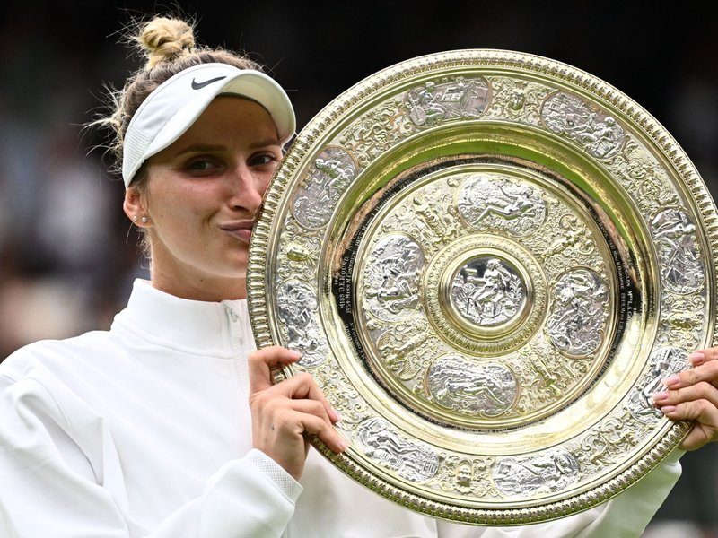 Marketa Vondrousova kisses Venus Rosewater Dish trophy after winning Wimbledon