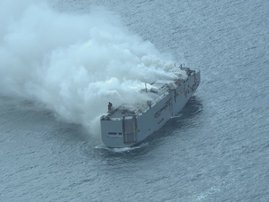 Dutch firefighters battled for a second day, on July 27, 2023, to douse a blaze on a cargo ship off the Netherlands coast suspected to have been started by electric cars.