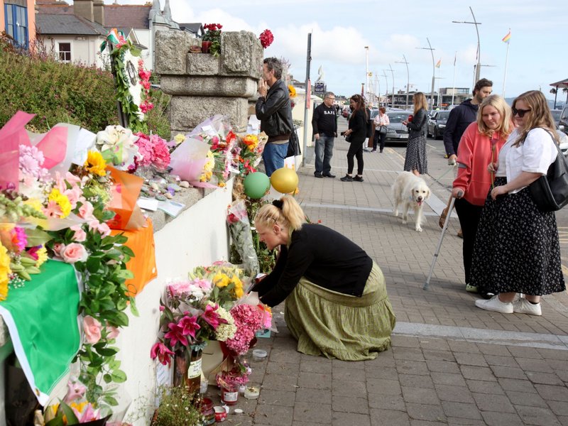 People lay flowers and tributes outside the former home of Irish singer Sinead O'Connor, in Bray, eastern Ireland, ahead of her funeral.