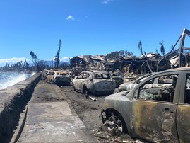 Burned cars and destroyed buildings are pictured in the aftermath of a wildfire in Lahaina, western Maui, Hawaii on August 11, 2023
