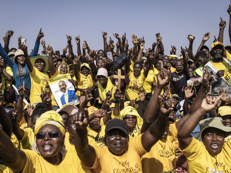 Supporters of the opposition leader for the Citizens Coalition for Change (CCC) Nelson Chamisa cheer during their final campaign rally in Harare on August 21, 2023.