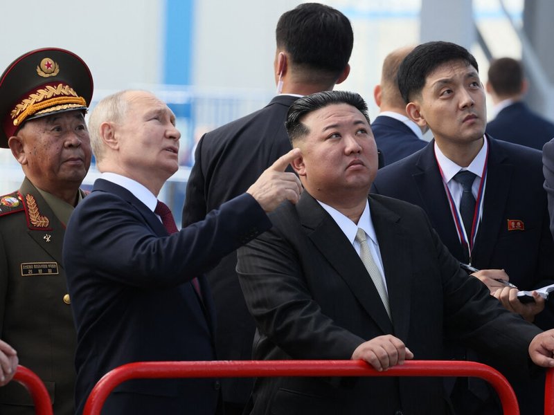 Russia's President Vladimir Putin (centre L) and North Korea's leader Kim Jong Un (centre R)