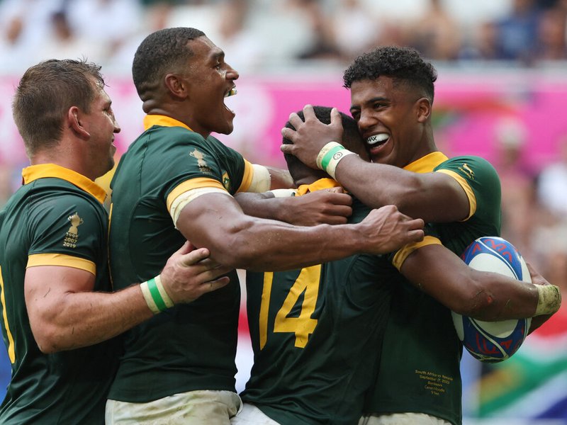 Springbok scrum-half Grant Williams (2nd R) celebrates with teammates at 2023 Rugby World Cup