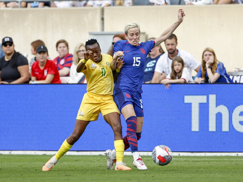 USA's forward Megan Rapinoe (R) fights for the ball with Banyana's Thembi Kgatlana