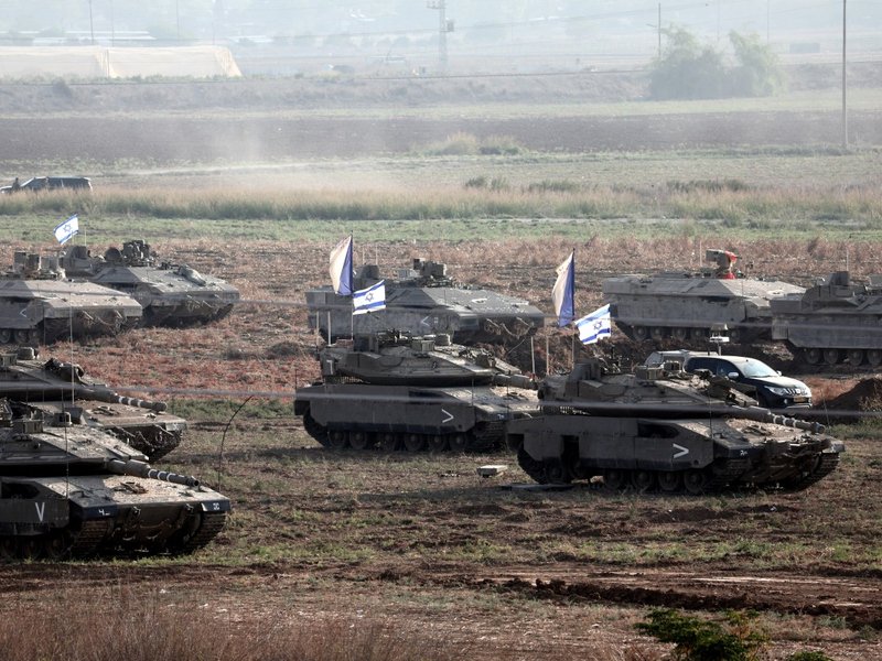 Israeli troops in tanks and other armoured vehicles amass in a field near the southern Israeli city of Ashkelon