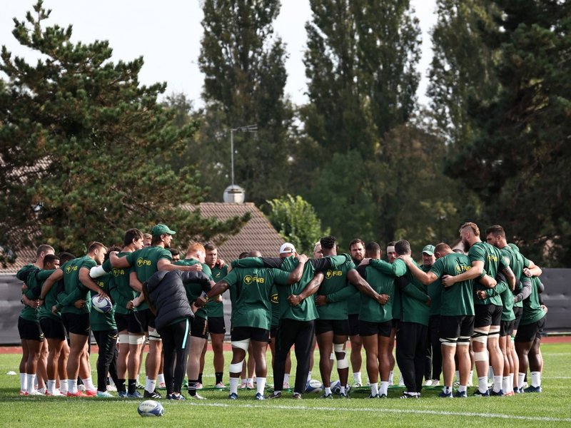 Springbok pplayers link arms as they form huddle during a training session