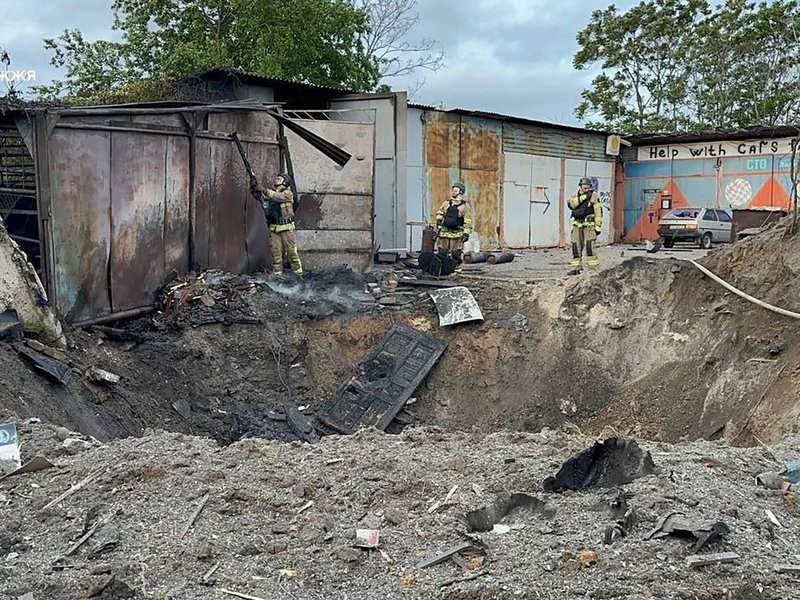 rescuers working next to a crater following a missile attack in Zaporizhzhia, amid the Russian invasion of Ukraine.