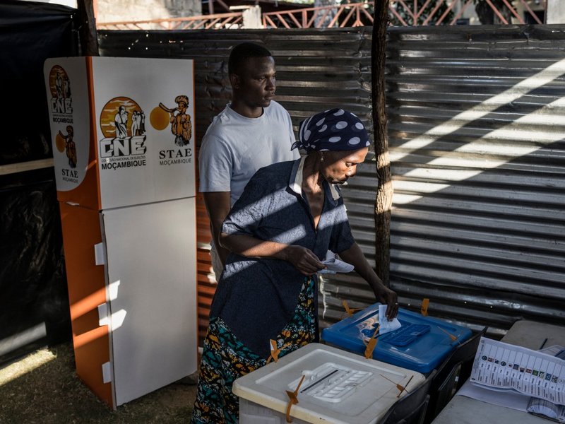 A voter casts her ballot at a temporary polling station in the Jardim district of Maputo on October 9, 2024 during Mozambique's national election.