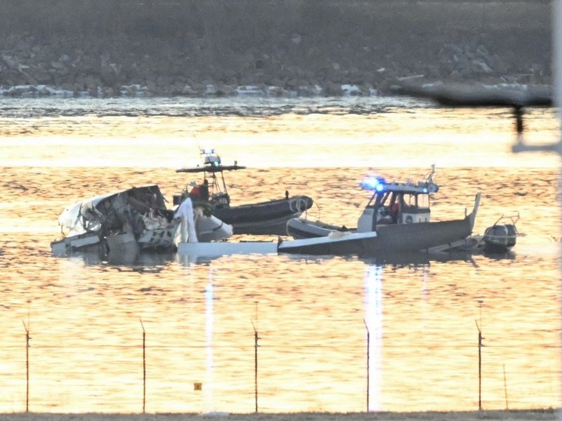 Part of the wreckage is seen as rescue boats search the waters of the Potomac River after a plane on approach to Reagan National Airport crashed into the river outside Washington, DC, January 30, 2025.