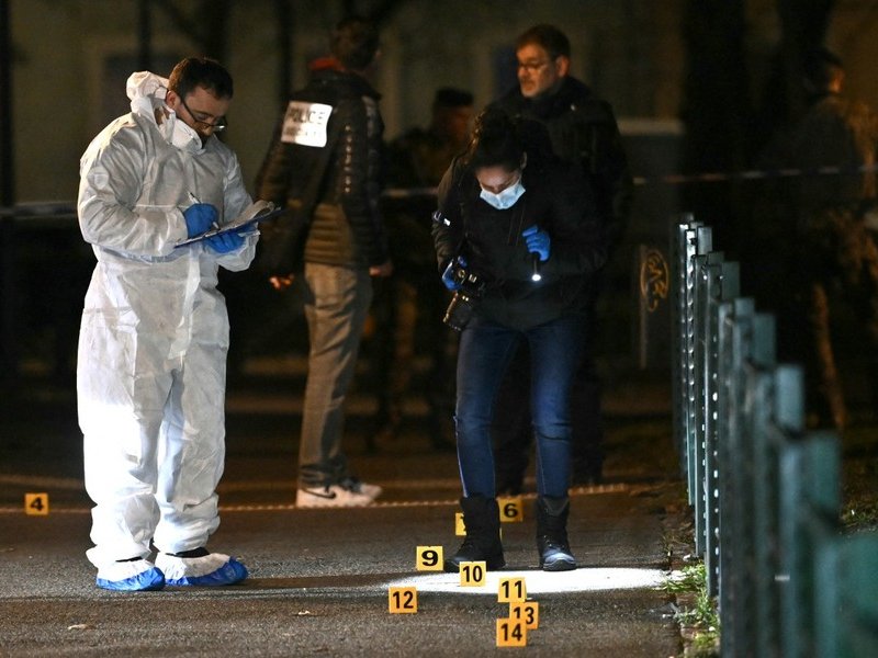 French forensic police work on the site of a knife attack where a man is suspected of killing one person and seriously wounding two police officers