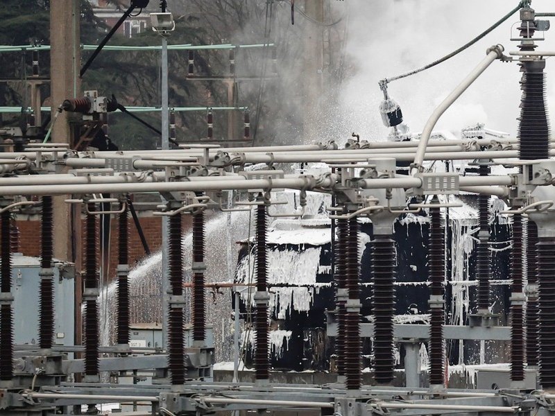 Firefighters douse the remainder of a fire that broke out at a substation supplying power to Heathrow Airport