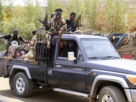 Sudanese army soldiers celebrate as they patrol in Salha, south of Omdurman, two days after the Sudanese army recaptured it from the paramilitary Rapid Support Forces (RSF)