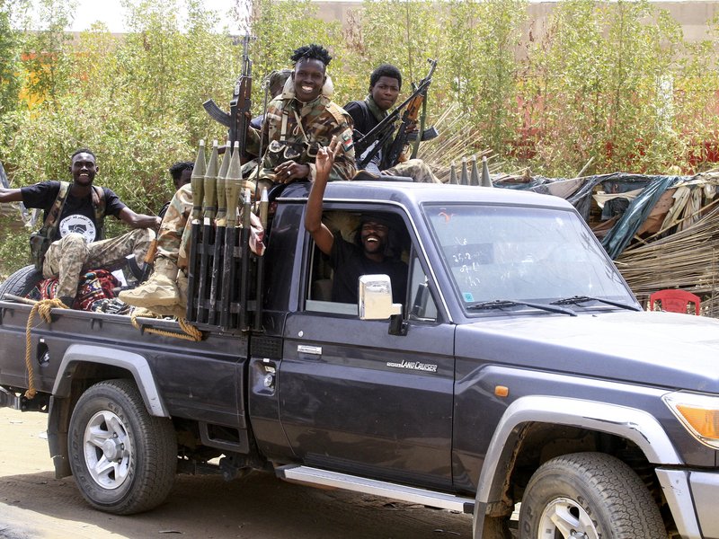 Sudanese army soldiers celebrate as they patrol in Salha, south of Omdurman, two days after the Sudanese army recaptured it from the paramilitary Rapid Support Forces (RSF)