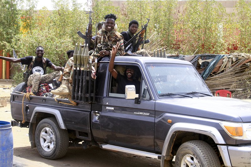 Sudanese army soldiers celebrate as they patrol in Salha, south of Omdurman, two days after the Sudanese army recaptured it from the paramilitary Rapid Support Forces (RSF)