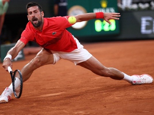Serbia's Novak Djokovic plays a forehand return to Austria Filip Misolic
