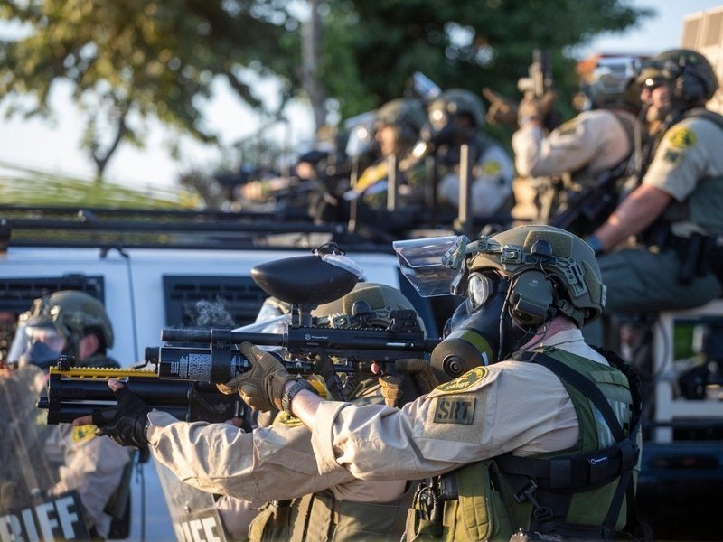 Law enforcement confronts demonstrators during a protest following federal immigration operations, in the Compton neighborhood of Los Angeles
