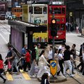 People cross a street in Hong Kong