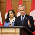 Canadian Prime Minister Mark Carney (R), flanked by Canadian Foreign Affairs Minister Anita Anand, speaks during a press conference
