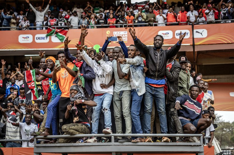 Kenyan fans react as they watch from an elevated platform during during the African Nations Championship (CHAN)