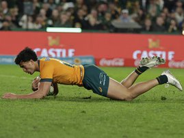 Australia's centre Joseph Aukuso-Suaalii dives across the line to score a try during the Rugby Championship first round Test match between South Africa and Australia at the Ellis Park Stadium in Johannesburg