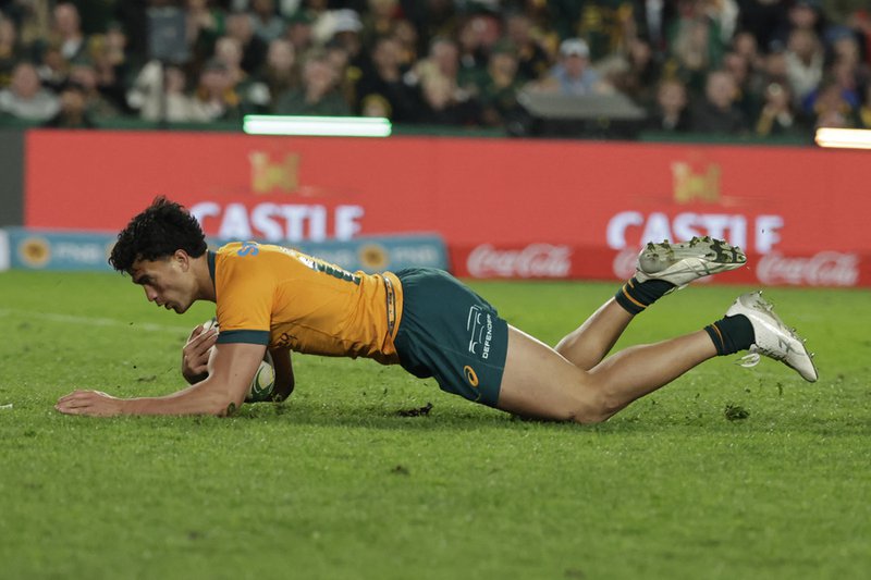 Australia's centre Joseph Aukuso-Suaalii dives across the line to score a try during the Rugby Championship first round Test match between South Africa and Australia at the Ellis Park Stadium in Johannesburg