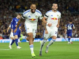 Leeds United's German striker #14 Lukas Nmecha (L) celebrates after scoring the opening goal from the penalty spot during the English Premier League football match
