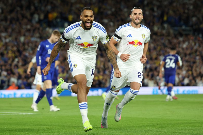 Leeds United's German striker #14 Lukas Nmecha (L) celebrates after scoring the opening goal from the penalty spot during the English Premier League football match