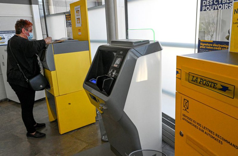 A woman posts mail at the Lunel post office south of France