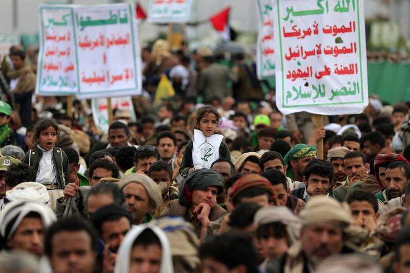 Yemenis lift placards during a rally in solidarity with Palestinians and in condemnation of Israel and the US