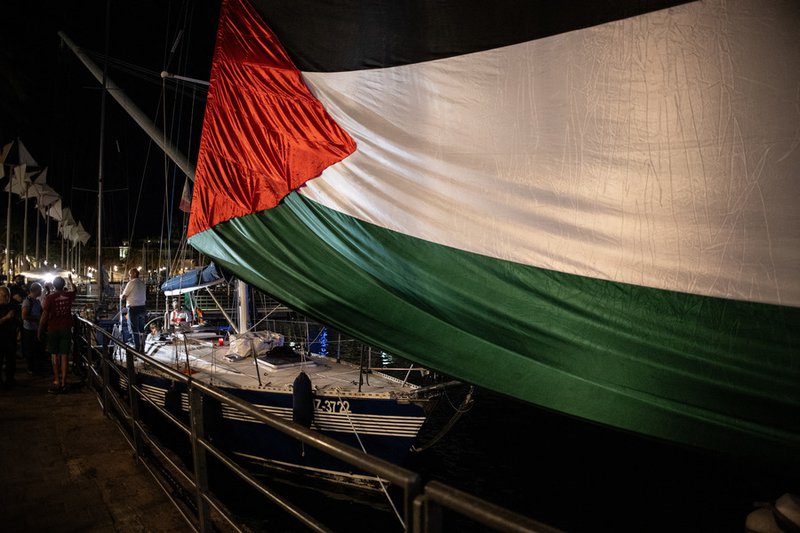 A giant Palestinian flag is deployed where four boats will leave to Gaza joining the “Global Sumud Flotilla”