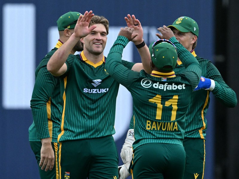 South Africa's Wiaan Mulder (C) celebrates with teammates after taking the wicket of England's Jos Buttler during the first One Day International (ODI) cricket match between England and South Africa