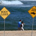Visitors walk along the shoreline as northern Sydney beaches remain closed following a suspected shark attack at Long Reef