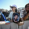 A faithful holds a portrait of late Blessed Carlo Acutis