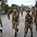Nepal army personnel patrol along a street