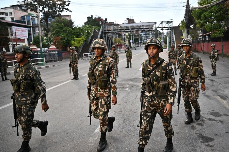 Nepal army personnel patrol along a street