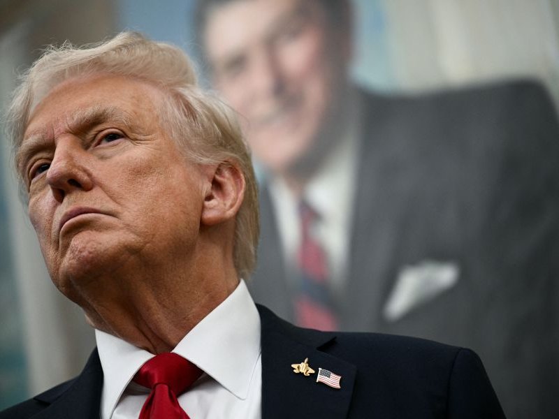 A portrait of former US President Ronald Reagan hangs behind US President Donald Trump